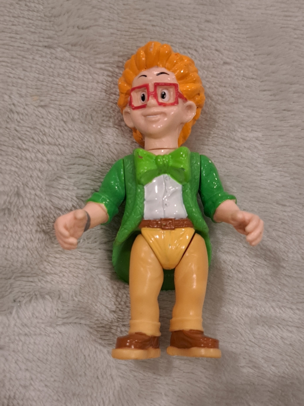 Green-Jacket Boy Figurine with Orange Hair and Red Glasses